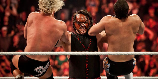 Kane taking down two top stars during WWE "Raw" event at the Rose Garden Arena in Portland, Oregon on February 27, 2012.