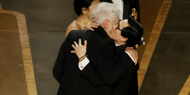 Ke Huy Quan accepted the award for Best Picture for "Everything Everywhere Everything at once" from Harrison Ford on stage during the 95th Annual Academy Awards.