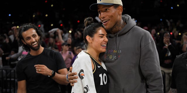 NFL player Darren Waller hugs Las Vegas Aces No. 10 Kelsey Plum after the first round of Game 1 of the 2022 WNBA Playoffs, August 17, 2022 at the Michelob ULTRA Arena in Las Vegas, Nevada.