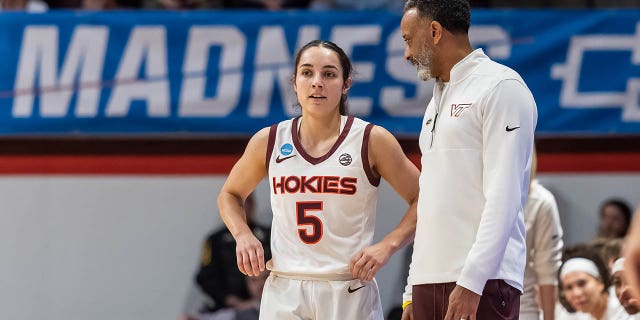 Kenny Brooks, head coach of the Virginia Tech Hokies, talks with Georgia Amoore during the first round of the NCAA Women's Basketball Tournament on March 17, 2023, in Blacksburg.