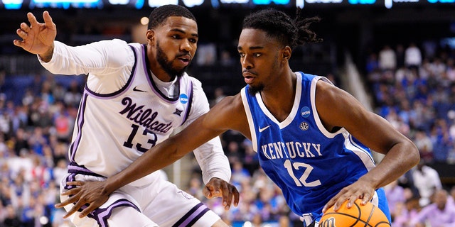 Antonio Reeves #12 of the Kentucky Wildcats drives against Desi Sills #13 of the Kansas State Wildcats during the second half in the second round of the NCAA Men's Basketball Tournament at The Fieldhouse at Greensboro Coliseum on March 19, 2023 in Greensboro, North Carolina.