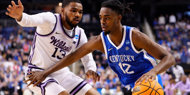 Antonio Reeves #12 of the Kentucky Wildcats drives against Desi Sills #13 of the Kansas State Wildcats during the second half in the second round of the NCAA Men's Basketball Tournament at The Fieldhouse at Greensboro Coliseum on March 19, 2023 in Greensboro, North Carolina.