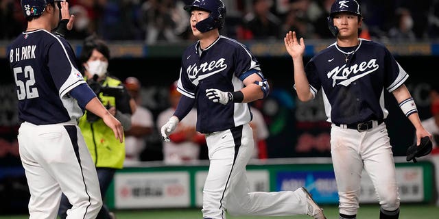 South Korea's Park Kun-woo celebrates with Park Have-min, right, and Park Byung-ho after hitting a grand slam during the fourth inning of the first round Pool B game between the South Korea and China at the World Baseball Classic at the Tokyo Dome in Tokyo Monday, March 13, 2023. 