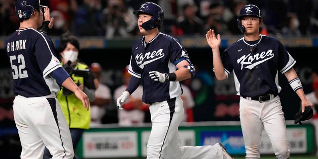 South Korea's Park Kun-woo celebrates with Park Have-min, right, and Park Byung-ho after hitting a grand slam during the fourth inning of the first round Pool B game between the South Korea and China at the World Baseball Classic at the Tokyo Dome in Tokyo Monday, March 13, 2023.