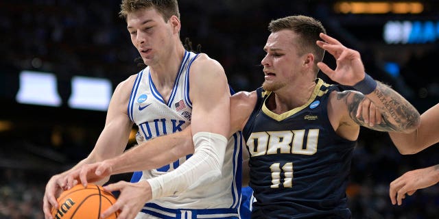 Duke center Kyle Filipowski, left, and Oral Roberts guard Carlos Jurgens (11) compete for a rebound during the first half of a first-round college basketball game in the NCAA Tournament, Thursday, March 16, 2023, in Orlando, Fla.