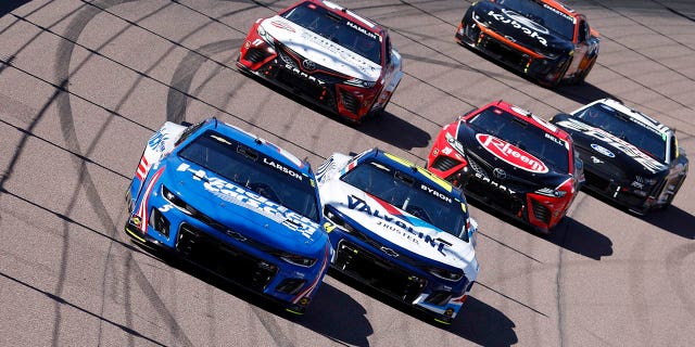 Kyle Larson, driver of the #5 HendrickCars.com Chevrolet, William Byron, driver of the #24 Valvoline Chevrolet, Denny Hamlin, driver of the #11 Shingrix Toyota, and Christopher Bell, driver of the #20 Rheem Toyota, race during the NASCAR Cup Series United Rentals Work United 500 at Phoenix Raceway on March 12, 2023 in Avondale, Arizona.