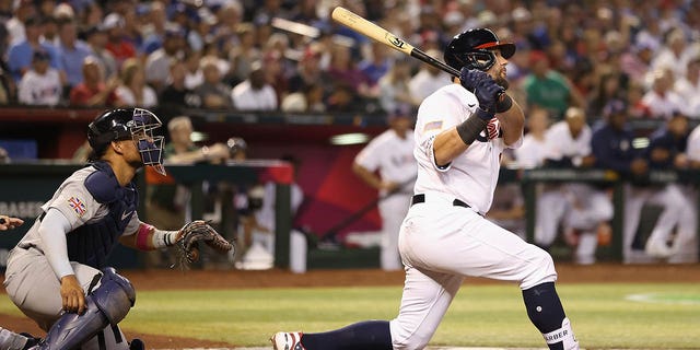 Kyle Schwarber, #12 of Team USA, hits a three-run home run against Team Great Britain during the fourth inning of a World Baseball Classic Pool C game at Chase Field on March 11, 2023 in Phoenix.
