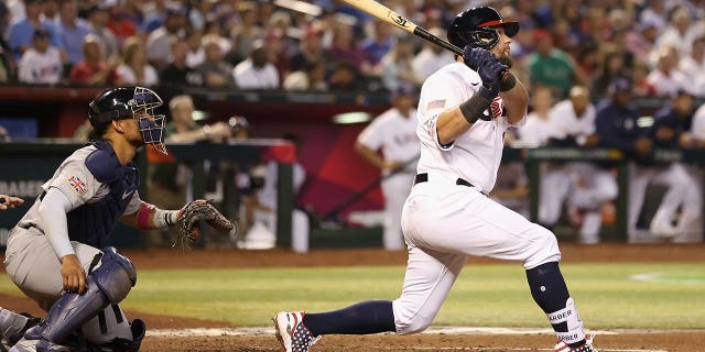 Kyle Schwarber, #12 of Team USA, hits a three-run home run against Team Great Britain during the fourth inning of the World Baseball Classic Pool C game at Chase Field on March 11, 2023 in Phoenix.