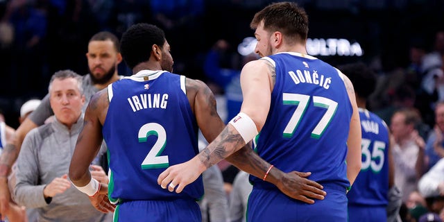 Kyrie Irving and Luka Doncic of the Dallas Mavericks celebrate in the second half of their game against the Philadelphia 76ers at American Airlines Center in Dallas on Thursday. 