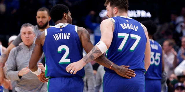 Kyrie Irving and Luka Doncic of the Dallas Mavericks celebrate in the second half of their game against the Philadelphia 76ers at American Airlines Center in Dallas on Thursday.