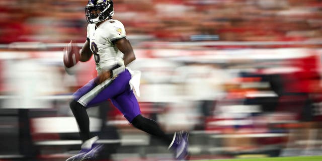 Lamar Jackson, #8 of the Baltimore Ravens, carries the ball during the fourth quarter of an NFL football game against the Tampa Bay Buccaneers at Raymond James Stadium on Oct. 27, 2022 in Tampa, Florida.