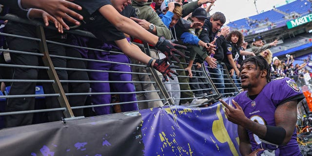 Quarterback Lamar Jackson of the Ravens greets fans after beating the Los Angeles Chargers at M&T Bank Stadium on Oct. 17, 2021, in Baltimore.