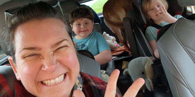Sherry Lankston (front) and her two children, Harrison (back left) and Fionnlagh (back right) drove over 2,600 miles in total to retrieve their new pup.
