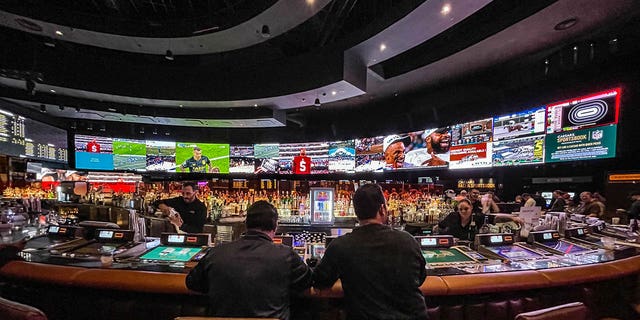 Gamblers flow into Caesars Sports Book at Caesars Palace Hotel &amp; Casino to watch and bet on the Kansas City Chiefs vs Philadelphia Eagles in the National Football League's Super Bowl LVII (which is taking place in Glendale, Arizona) as viewed on February 12, 2023 in Las Vegas, Nevada.