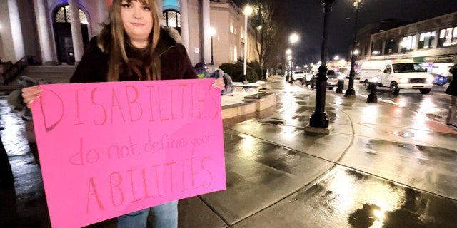 Laura Green with fellow demonstrators outside Framingham City Hall protesting comments from Michael Hugo.