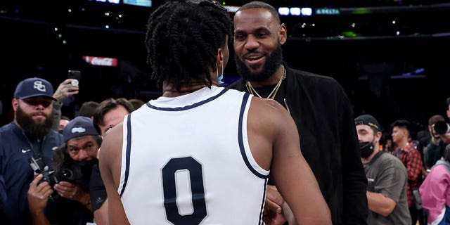 LeBron James, #6 of the Los Angeles Lakers, talks with his son Bronny James, #0 of Sierra Canyon, after the game against St. Vincent - St. Mary during The Chosen-1's Invitational at Staples Center on Dec. 4, 2021 in Los Angeles.
