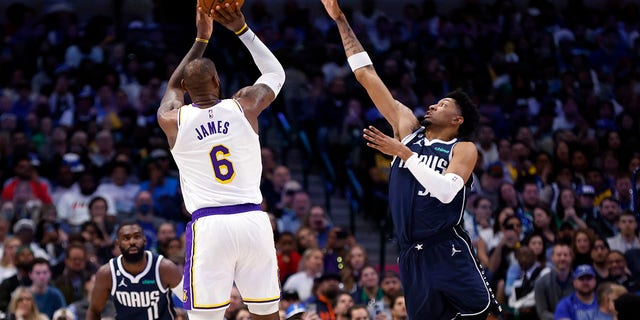 Los Angeles Lakers' LeBron James (6) shoots the ball as Dallas Mavericks' Christian Wood (35) defends in the first half of a game at American Airlines Center on February 26, 2023 in Dallas, Texas.