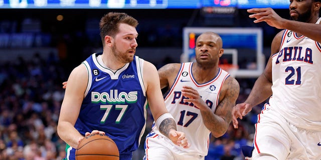 Dallas Mavericks' Luka Doncic handles the ball as Philadelphia 76ers' Joel Embiid, far right, and PJ Tucker defend in the second half of the game at the American Airlines Center in Dallas on Thursday.