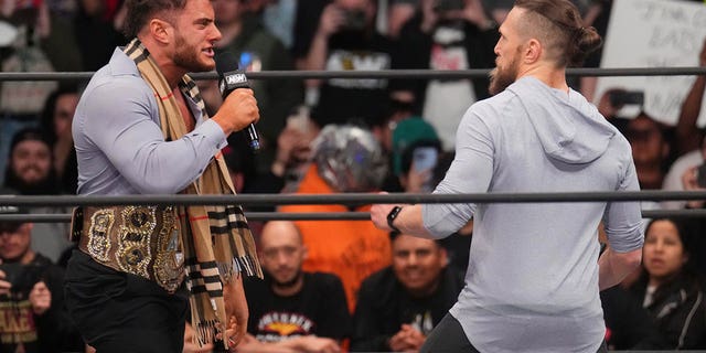 Feb 22, 2023; Phoenix, AZ, USA; AEW Champion Maxwell Jacob Friedman aka MJF  (suit) and Bryan Danielson (hoodie) come face-to-face during AEW Dynamite at Footprint Center. 