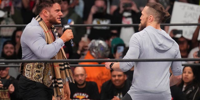 Feb 22, 2023; Phoenix, AZ, USA; AEW Champion Maxwell Jacob Friedman aka MJF  (suit) and Bryan Danielson (hoodie) come face-to-face during AEW Dynamite at Footprint Center. 