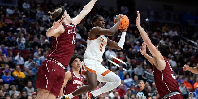 Texas guard Marcus Carr, center, passes between Colgate forward Keegan Records, left, and guard Oliver Lynch-Daniels, right, in the second half of a first-round college basketball game in the NCAA Tournament, Thursday, March 16, 2023, in Des Moines, Iowa. 