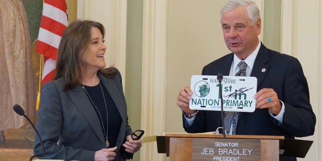 Democratic presidential candidate Marianne Williamson is greeted by New Hampshire state Senate president Jeb Bradley, at the Statehouse in Concord, N.H. on March 9, 2023