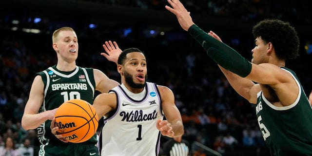 Kansas State guard Markquis Nowell (1) passes around the defense of Michigan State forward Malik Hall in the second half of a Sweet 16 college basketball game in the East Regional of the NCAA tournament at Madison Square Garden, Thursday, March 23, 2023, in New York.