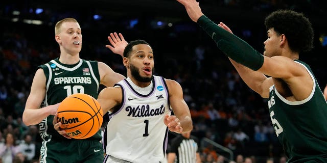 Kansas State guard Markquis Nowell (1) passes around the defense of Michigan State forward Malik Hall in the second half of a Sweet 16 college basketball game in the East Regional of the NCAA tournament at Madison Square Garden, Thursday, March 23, 2023, in New York.