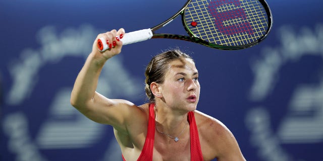 Marta Kostyuk of Ukraine in action against Ipek Oz of Turkey during her women's singles match on day one of the Dubai Duty Free Tennis at Dubai Duty Free Tennis Stadium on February 19, 2023 in Dubai, United Arab Emirates.