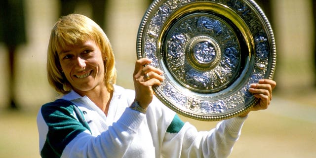 Martina Navratilova holds up the winner plate after winning the Wimbledon Championships played at Wimbledon, London.