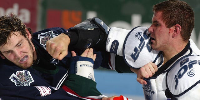 Shawinigan Cataractes' Marty Doyle and Gatineau Olympiques' David Starenky fight during a Quebec Major junior hockey game at the Center Robert-Guertin on October 22, 2004, in Gatineau, Quebec, Canada.