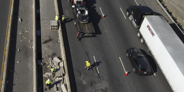 The Acura vehicle involved in the crash Wednesday is seen being towed away from the scene.