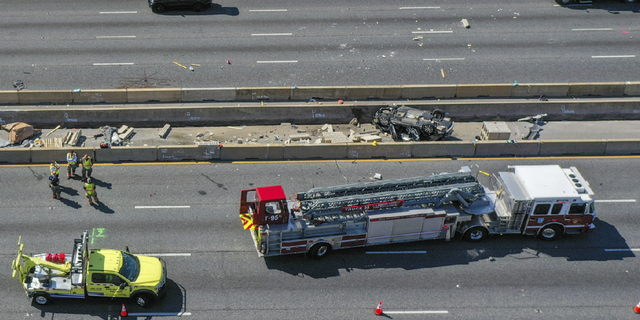 Emergency personnel work at the scene of fatal crash along Interstate 695 near Woodlawn, Maryland, on Wednesday, March 22.