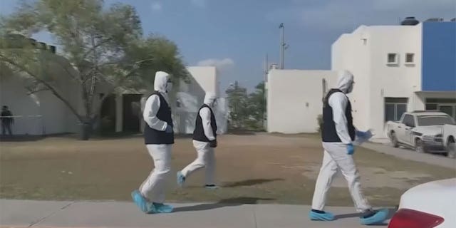 Medical professionals walking on a street in Mexico.