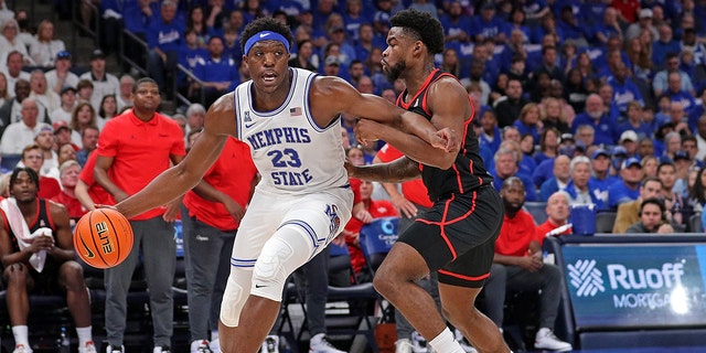 Malcolm Dandridge of the Tigers drives against Jamal Shead of the Houston Cougars at FedExForum on March 5, 2023 in Memphis, Tennessee.