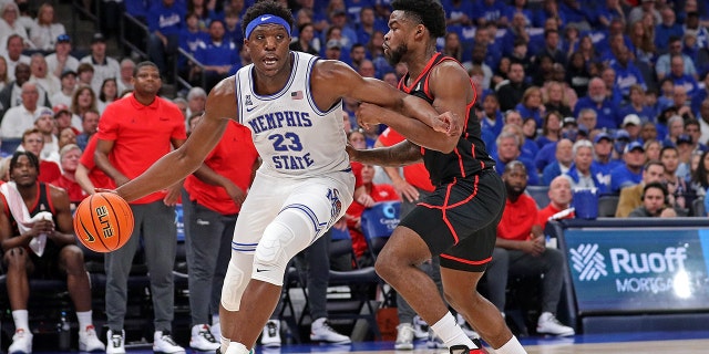Malcolm Dandridge of the Tigers drives against Jamal Shead of the Houston Cougars at FedExForum on March 5, 2023, in Memphis, Tennessee.