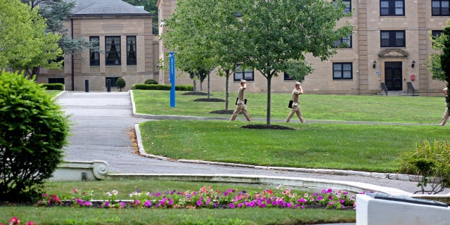 Midshipmen salute each other as they walk to class at the U.S. Merchant Marine Academy in Kings Point, New York, on Aug. 1, 2016.