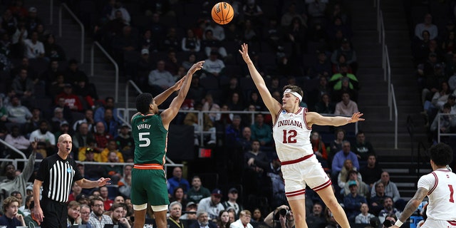 Harlond Beverly #5 of the Miami Hurricanes shoots over Miller Kopp #12 of the Indiana Hoosiers in the second half during the second round of the NCAA Men's Basketball Tournament at MVP Arena on March 19, 2023, in Albany, New York.