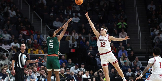 Harlond Beverly #5 of the Miami Hurricanes shoots over Miller Kopp #12 of the Indiana Hoosiers in the second half during the second round of the NCAA Men's Basketball Tournament at MVP Arena on March 19, 2023, in Albany, New York.