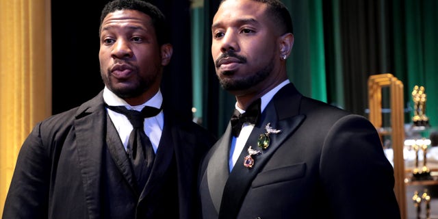 Michael B. Jordan and Jonathan Majors pose backstage at the Oscars
