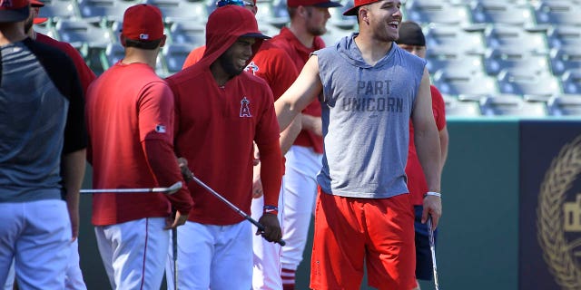 David Fletcher, #6, Luis Rengifo, #4, and Mike Trout, #27 of the Los Angeles Angels, get ready to hit golf balls in left field before playing the Oakland Athletics at Angel Stadium of Anaheim on June 28, 2019 in Anaheim, California.