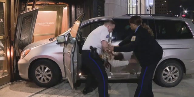 Officers swarmed the minivan after the vehicle crashed into the doors of the building.