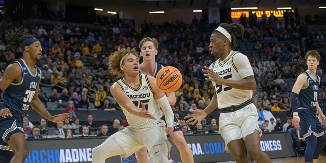 Missouri forward Noah Carter passes the ball to guard Sean East II during the first half of a first-round college basketball game against Utah State in the NCAA Tournament in Sacramento, Calif., Thursday, March 16, 2023. 