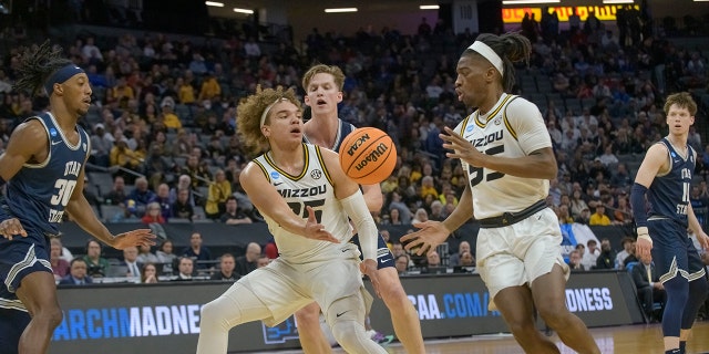 Missouri forward Noah Carter passes the ball to guard Sean East II during the first half of a first-round college basketball game against Utah State in the NCAA Tournament in Sacramento, Calif., Thursday, March 16, 2023.