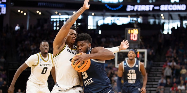 Utah State guard RJ Eytle-Rock (5) is defended by Missouri Tigers guard DeAndre Gholston (4) as he drives to the basket during the first half of a first-round college basketball game in the NCAA Tournament in Sacramento, Calif., Thursday, March 16, 2023. Thursday, March 16, 2023.