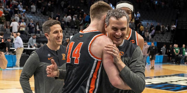 Princeton head coach Mitch Henderson embraces guard Matt Allocco (14) after their first-round win over Arizona in the NCAA tournament in Sacramento, Calif., Thursday, March 16, 2023.