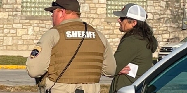 Tim Bliefnick speaks with a deputy as investigators search his home on Wednesday, March 1, 2023. Police left without making any arrests but said they temporarily detained someone during the execution of a search warrant in connection with the shooting death of his estranged wife, Becky Bliefnick.