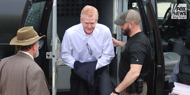 Alex Murdo (center) is escorted into the Colleton County Courthouse in Walterboro, South Carolina on Wednesday, March 1, 2023.  Murdo stood trial for the double murder of his son Paul and wife Maggie in June 2021.