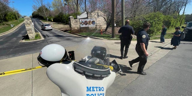 Metro Nashville Police Department officers walk outside the Covenant School, Covenant Presbyterian Church, in Nashville, Tennessee, Monday, March 27, 2023.