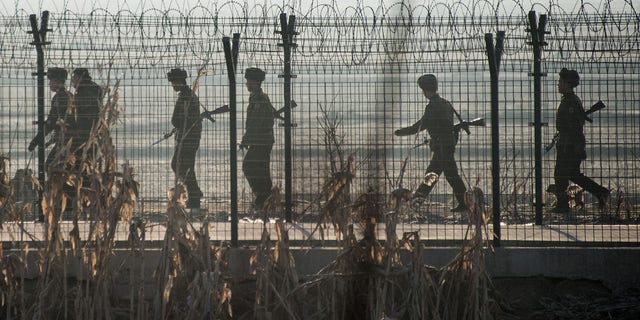 File: North Korean soldiers patrol near the border fence near the town of Sinuiju across from the Chinese border town of Dandong. 